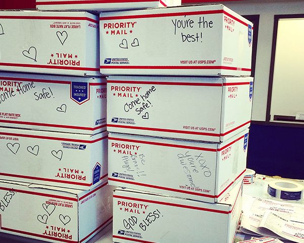 Military Care Packages, USPS packages stacked at a post office