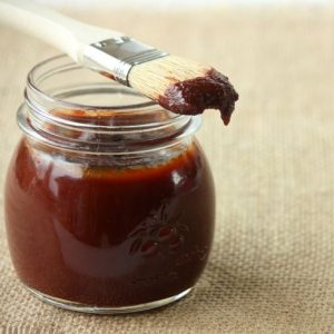 Rool Over Pic BQ Sauce,. BBQ sauce in a jar with a basting brush on it